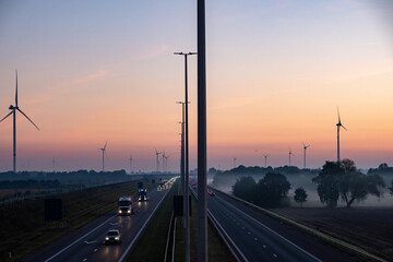 Aerial view of sunrise over a highway with traffic on a light misty morning in Belgium, Europe. High quality photo