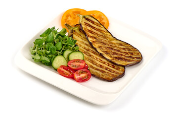 Grilled eggplants on stone black plate, isolated on white background.