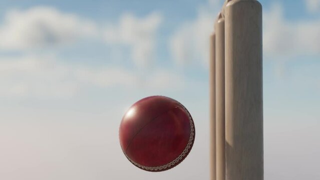 A slow motion close up of a red leather stitched cricket ball hitting wooden wickets