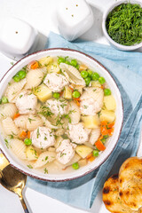 Homemade soup with chicken and turkey meatballs, shell Conchiglie pasta and vegetables, with greens. White meat broth with vegetables and macaroni, healthy diet food, children's lunch