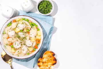 Homemade soup with chicken and turkey meatballs, shell Conchiglie pasta and vegetables, with greens. White meat broth with vegetables and macaroni, healthy diet food, children's lunch