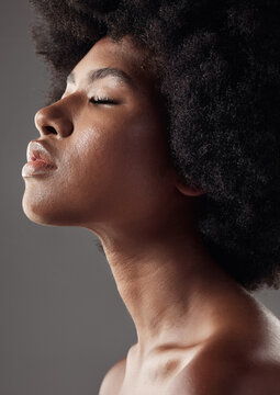 Natural hair care, profile and black woman with afro hairstyle, beauty and skincare on grey background. Natural haircare, cosmetics and face closeup of African model with skin glow or shine in studio