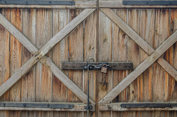 Old wooden gate with padlock
