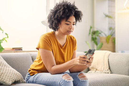 Phone, Relax And Woman On Sofa In Home Living Room For Social Media, Internet Scroll Or Texting. Mobile, Serious Or African Person On Couch In Lounge For Online App, Website Or Reading Email In House