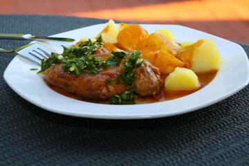 ossobuco with potatoes, sauce and gremolata, italian food, close up,