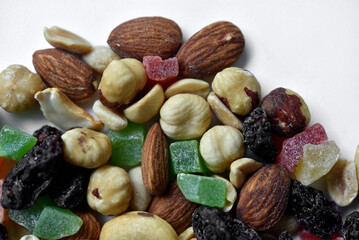 Nut mixture on a white background. A delicious snack of nuts and dried fruits.
