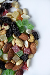 Nut mixture on a white background. A delicious snack of nuts and dried fruits.