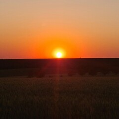 A sunset over a field