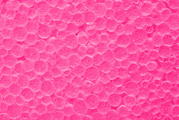 Texture of pink foam plastic. Pink textured background.
