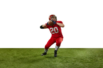 Concentrated man in red uniform, american football player in motion during game, serving ball over...