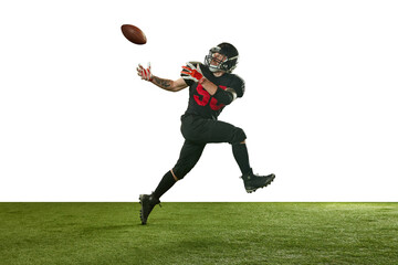 Concentrated man, american football player in black uniform in motion, running and catching ball...