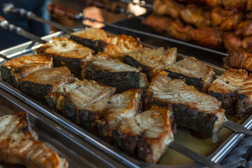 Grilled fried fish on the counter. Popular tasty street food. Close-up.