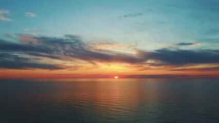 Aerial View of the Baltic Sea at Sunset, Pavilosta, Latvia. Beautiful Golden Sunset Over the Beach Seascape. Glittering Sunlight Reflection. The Baltic Sea at the Mouth of Saka River in Courland