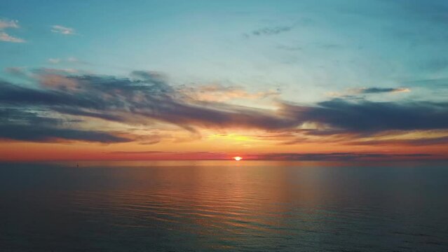 Aerial View of the Baltic Sea at Sunset, Pavilosta, Latvia. Beautiful Golden Sunset Over the Beach Seascape. Glittering Sunlight Reflection. The Baltic Sea at the Mouth of Saka River in Courland