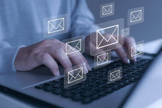 Businessman and e-mail icon on virtual screen, email marketing concept The company sends bulk emails or digital newsletters to its customers.