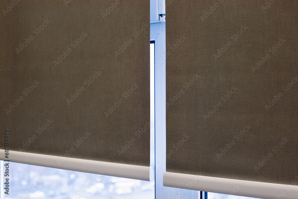 Aufkleber roller blinds closeup on the window. selective fokus. motorized roller shades. gray color, texture m