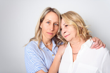Studio shot of two women. senior Mother and Daughter.