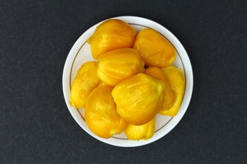 Jackfruit in a plate on black background top view 