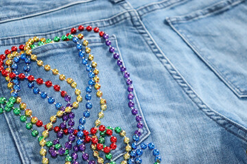 Rainbow beads in back pocket of jeans