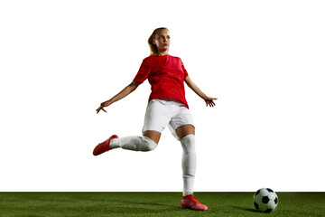 Young girl, female football player training, playing on sports field against white background....