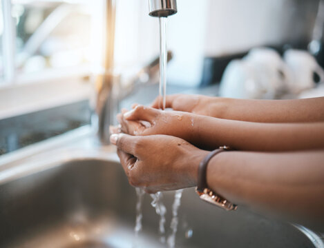 Washing hands, kitchen and parent with a child in their home for hygiene or cleaning at the sink. Children, water and tap with a kid learning about protection from an adult person in their house
