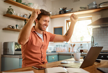 Happy, businessman celebrating and with laptop for remote work in kitchen of his home. Success or...