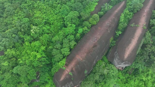 aerial view of Hin Sam Wan which is covered with green trees and there is a light mist