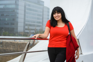 Young Venezuelan woman smiling looking at the camera standing on the Puente De La Mujer in Buenos Aires