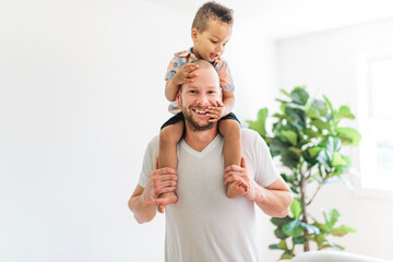 Obraz premium Father And Son Cuddling On living room Together