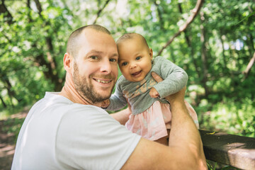Fototapeta premium father with her newborn daughter in the forest.