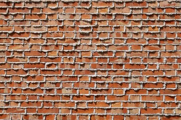 Red brick wall with excess and unscraped white mortar. Background and texture. Copy space.