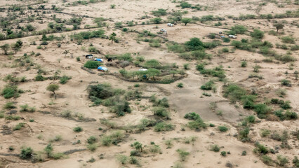 Aerial view of the dry sahel with desert livestock herders in Ethiopia near Somalia.