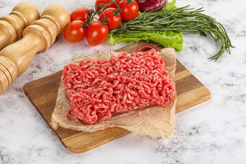Raw minced beef meat on cutting board