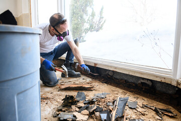 Working try to repair a broken window. Water inside