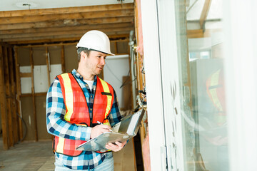 Inspector with white helmet inspecting an old house to be sure everything is well build