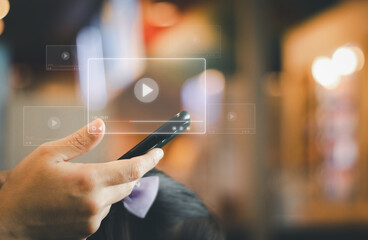 hand holding a phone to watch movie and watching live on virtual screen of multimedia platforms. concept of internet video streaming watch tv online , digital technology with content