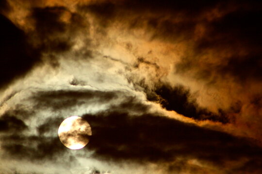 Over-exposed moon in the clouds at night