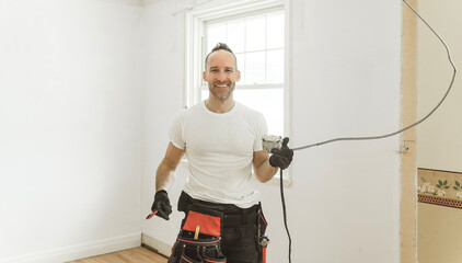 male electrician works working on a old house