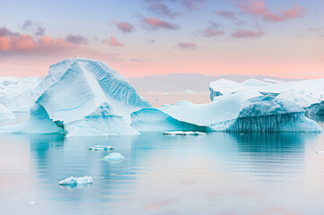 Icebergs in Atlantic ocean at sunset. Ilulissat icefjord, western Greenland..