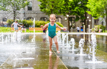 Adorable little girl have fun on hot sunny summer day