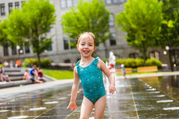 Adorable little girl have fun on hot sunny summer day