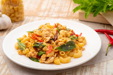Stir-fried elbow macaroni with ground chicken in white plate,Pad Kra Pao,Thai fusion food