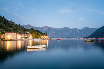 Evening panoramic view of the picturesque town of Perast in the Bay of Kotor with the promenade, beautiful historic buildings and boats, Montenegro.