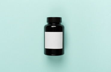 Plastic bottle with vitamins on color background, top view