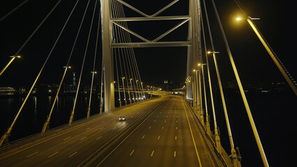 Fototapeta premium Top view elements metal structure modern cable stayed car bridge in night city