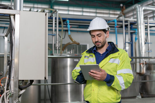 Mechanic or maintenance or electrical engineer checking main electrical control systems industrial plant. Utility fore man daily check power systems in process. Main Distribution Board, Switchboards