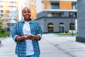 A young casually dressed girl holds the phone in her hand while waiting for her friends to go and socialize