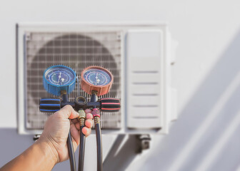 Air conditioner technician checking air conditioner operation	