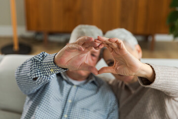 Love heart shape peace. Senior older couple making heart shape with their hands. Adult mature old husband wife showing heart sign. Happy pensioner family. I love you happy valentines day