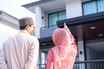 Happy muslim family standing at new home